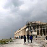 the acropolis of athens under gray, cloudy sky