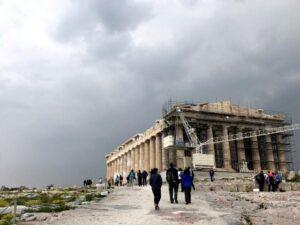 the acropolis of athens under gray, cloudy sky