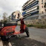 old red vespa in street in athens