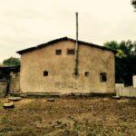 house wall with thin chimney on side