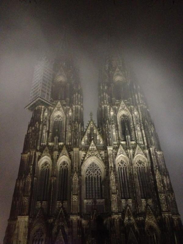 cologne cathedral facade in a foggy night