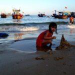 girl building sand castle at dai lanh beach