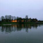 evening view of hampton court palace from the opposite bank on thames river