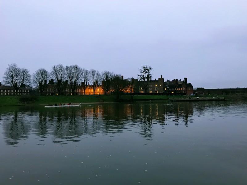 evening view of hampton court palace from the opposite bank on thames river
