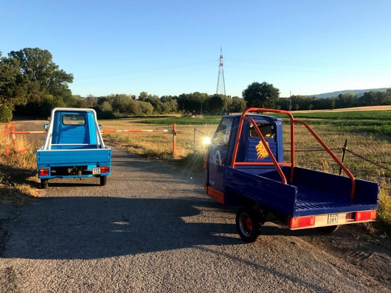 Blue italian three wheel vehicles in fields in marche
