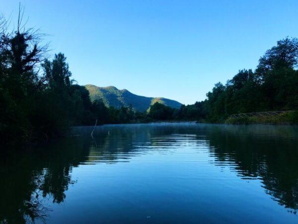 Morning view of fossi lake in marche with vapor upon surface