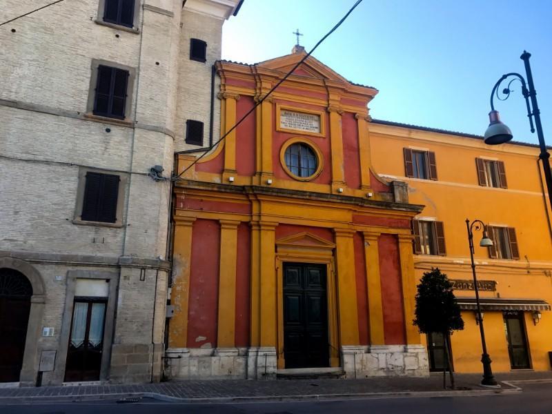 yellow orange church facade in pergola town in march italy