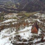 A drone picture of a house surrounded by snow in bajram curri, albania