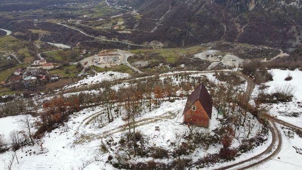 A drone picture of a house surrounded by snow in bajram curri, albania