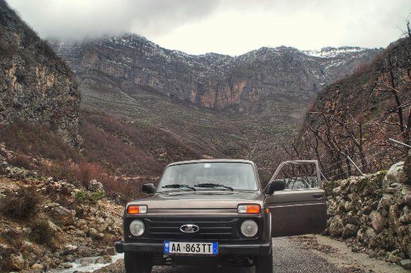 A car stood in front of rocky mountains in vukel, Shkoder County, albania