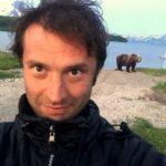 man taking a selfie with a bear at kurile lake national park in kamchatka