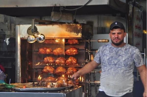 Iraqi man cooking chicken in Baghdad's streets