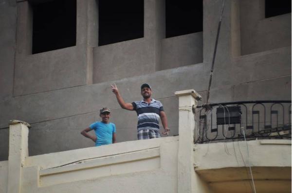 Iraqi construction workers waving at camera in Baghdad