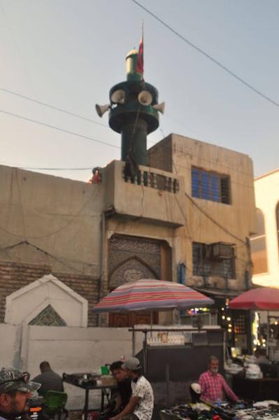 small mosque minaret with four megaphones in Baghdad