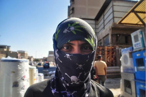 Iraqi man wearing a cannabis leaves and skulls head scarf in Baghdad