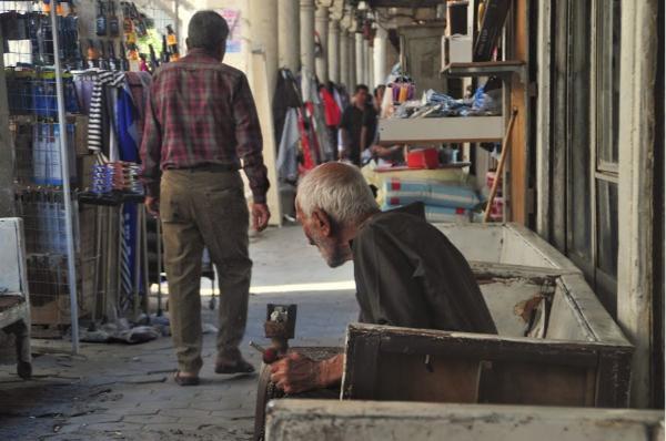 Senile Iraqi man smoking shisha in Baghdad's old town