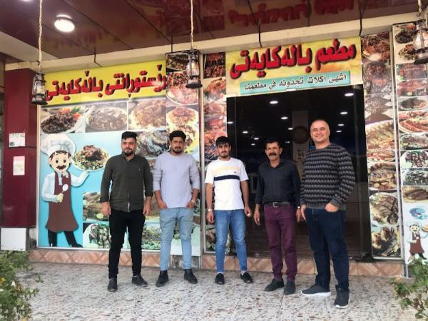 iraqi kurdish people in front of restaurant in choman village