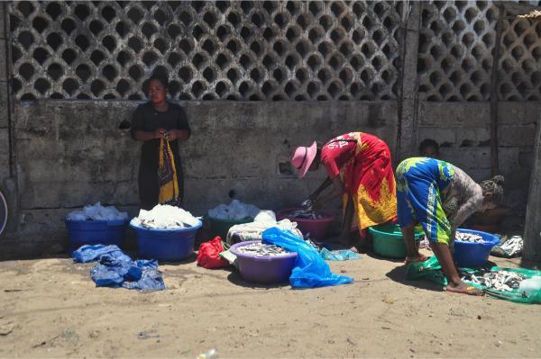 malagasy women doing laundry in a shade in the streets of morondava