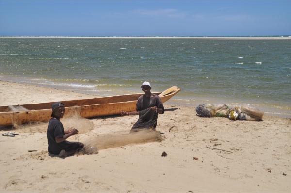 malagasy fishermen preparing nets at walking to the beach of morondava beach