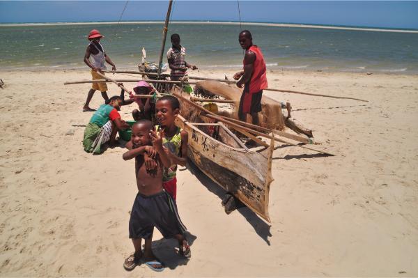 local family by fishing pirogue in morondava madagascar