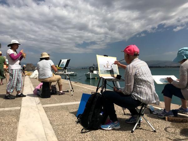 Painters at work on the port of nafplio greece