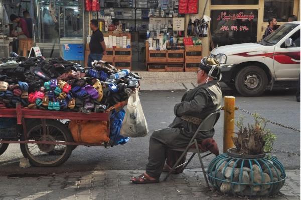 kurdish street vendor in traditional outfit in the streets of Sulaymaniyah