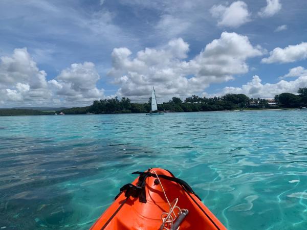 kayak bow entering crystal waters of blue bay in mauritius