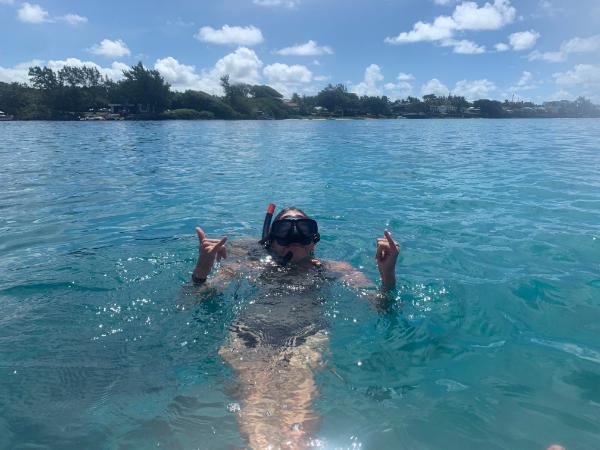 girl snorkeling in blue bay, mauritius