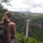 girl photographing the chamarel fall, tallest waterfall in mauritius