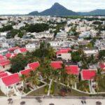 drone view of flic en flac town in mauritius with mountains in the background