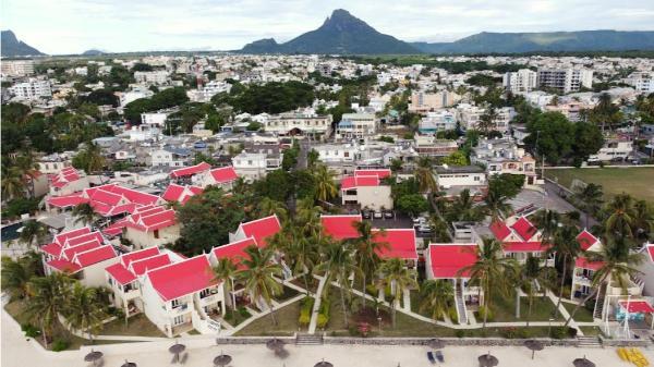 drone view of flic en flac town in mauritius with mountains in the background