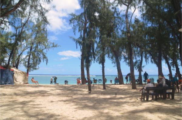 locals and tourists chilling at flic en flac beach in mauritius