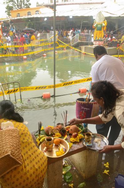 hindu mauritians placing offerings on the shore of ganga talao