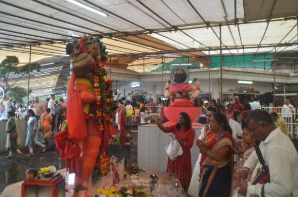 hindus praying before statue of god in grand bassin festival, mauritius