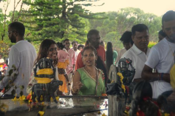 mauritian hindus walking around fountain at the great night of shiva festival at grand bassin