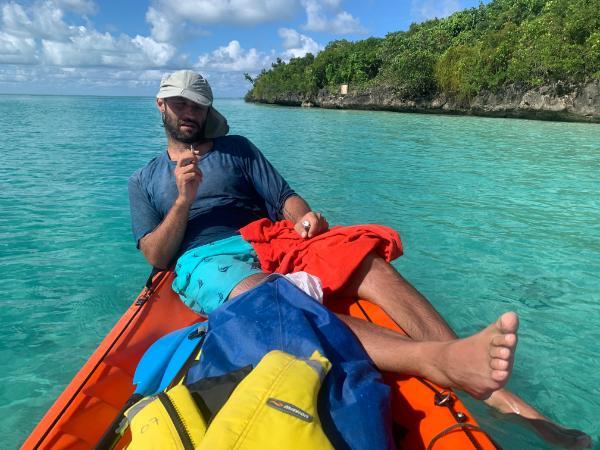 guy resting on kayak beside ile aux aigrettes island in mauritius 