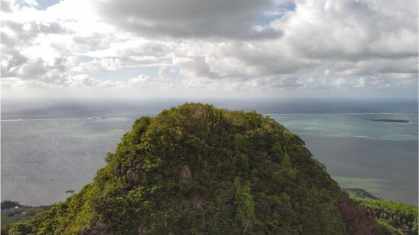 drone picture of the summit of lion mountain and the sea in the background in mauritius