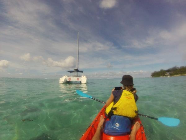 kayaking Past a catamaran at Pointe d’Esny Beach, mauritius