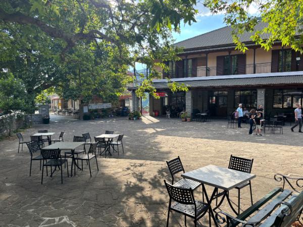 tables in the square of agia paraskevi (kerasovo) village on the foot of mount smolikas