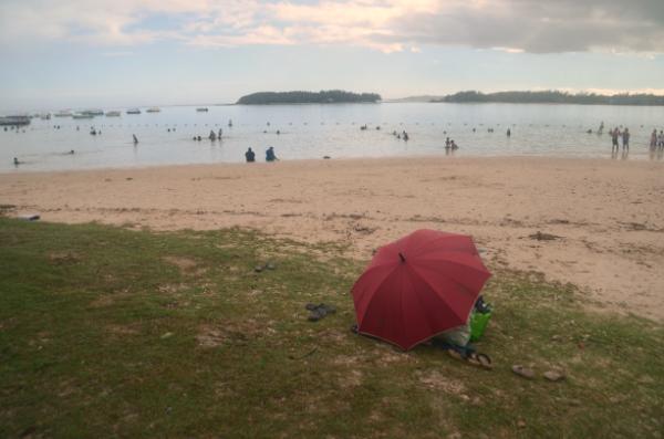 red parasol at Blue Bay public beach in mauritius