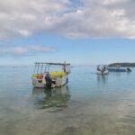 boat floating on calm waters of blue bay in mauritius