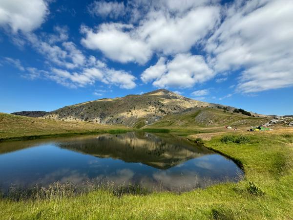 dragon lake and peak of mount smolikas in greece