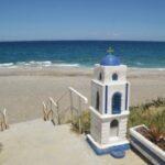 blue and white shrine before the aegean sea at mourteri beach on evia island