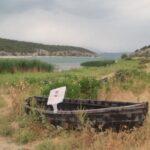 wooden boat on prespa lake shore in psarades village in greece