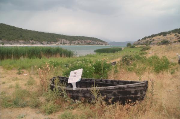 wooden boat on prespa lake shore in psarades village in greece