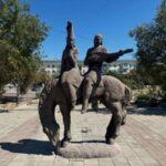 statue of horse carrying man with a traditional string instrument in balkhash, kazakhstan