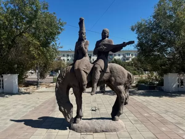 statue of horse carrying man with a traditional string instrument in balkhash, kazakhstan