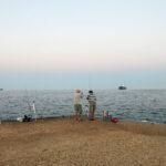 old men fishing at esplanade of thessaloniki, greece