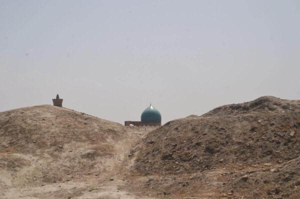 Distant turquoise mosque dome viewed from atop the fort of Bukhara