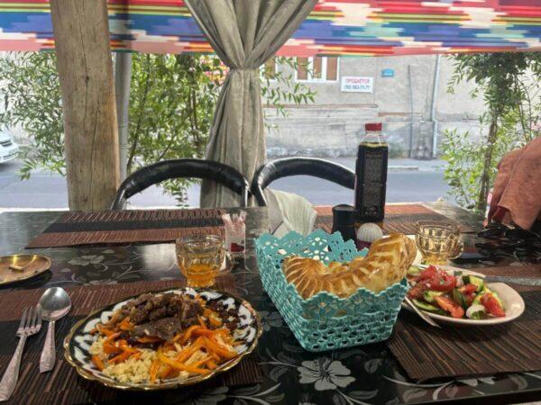 plov, salad, and flatbread meal in bukhara, uzbekistan